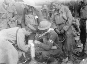 Wounded soldier receives first aid from stretcher bearer on frontline