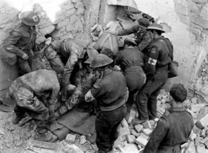 Stretcher bearers recovery casualty from rubble during Italian campaign 