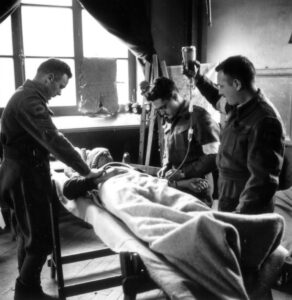 Patient receiving transfusion in an Advance Dressing Station (ADS) in Italy