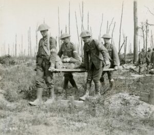 Stretcher bearers carry wounded from battlefield.
