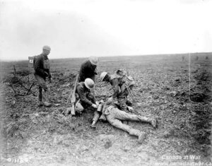 Wounded soldier receiving first aid on battlefield