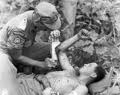 Medic providing first aid to wounded soldier in Korea