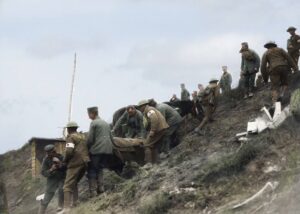 German POWs assist Canadian stretcher bearers carry casualty down difficult terrain Source: