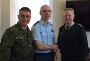 BGen MacKay and, Surg Gen, and BGen Eldaoud, COS MILPERSCOM, congratulate Col Roger Scott on his promotion.