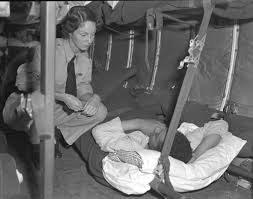 Royal Canadian Air Force nursing sister chatting with a patient from the Korean War as they take off for Canada Source: TBC