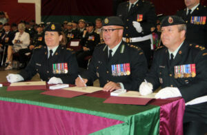 Col. Dwayne Lemon, deputy commander of the Canadian Forces Health Services Group (centre), officiates the signing ceremony as Lt.-Col. Doug Kromrey hands over command of 1 Canadian Field Hospital to Lt.-Col. Margaret Ann Coleman-McLean.